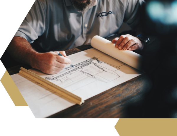 An architect working on a draft with a pencil and ruler