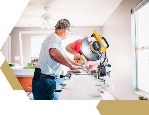 man standing infront of miter saw